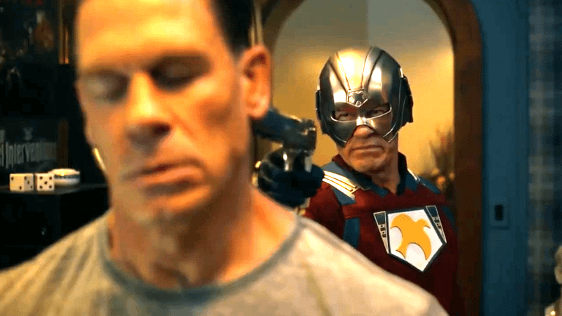John Cena as Peacemaker holding a gun to another version of himself in Peacemaker