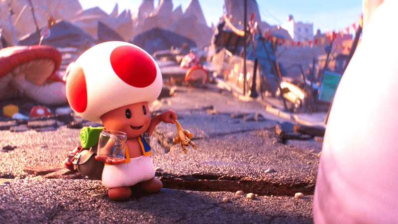Toad holding a small Bowser in The Super Mario Bros. Movie