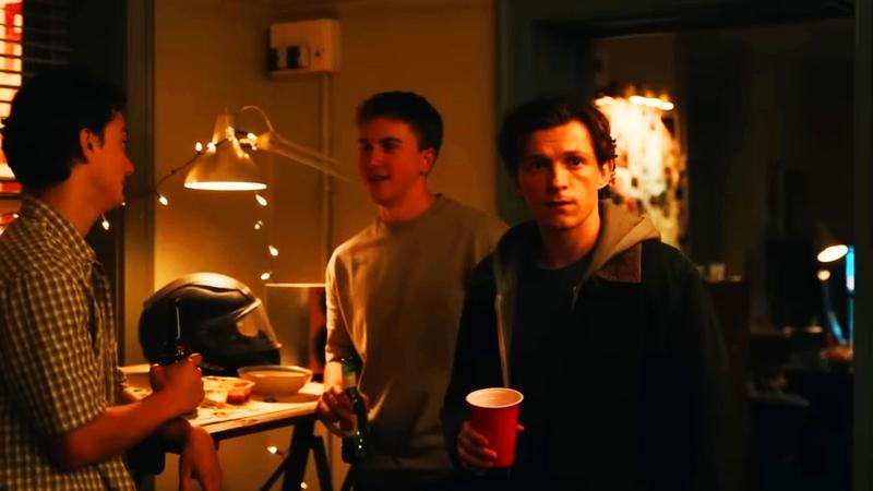 Peter Parker holding a red solo cup at the party.