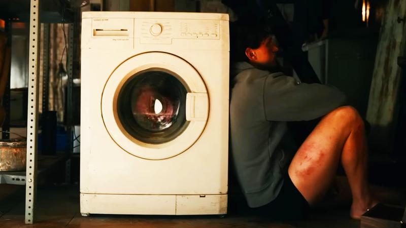 Peter leaning on his washing machine.