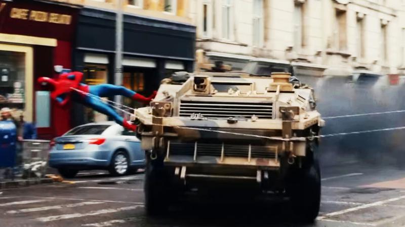Spider-Man using his webs to turn a tank.