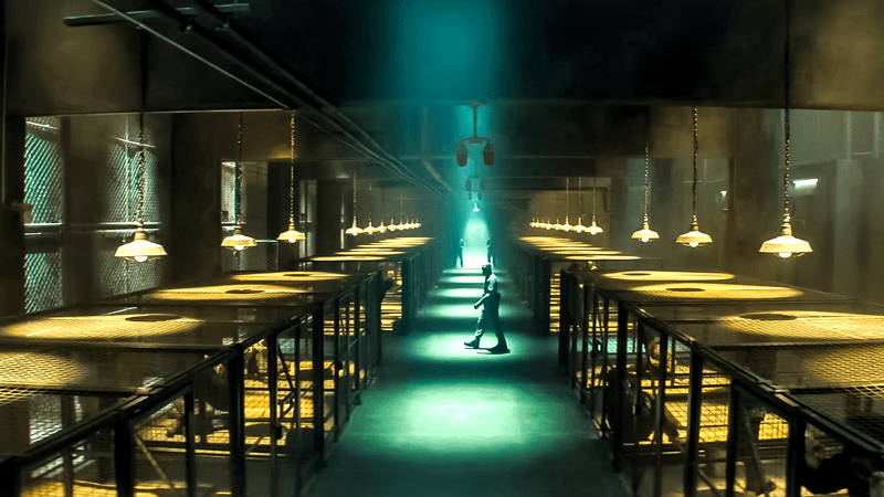 Several guards walking through a dimly-lit prison facility in Daredevil: Born Again.