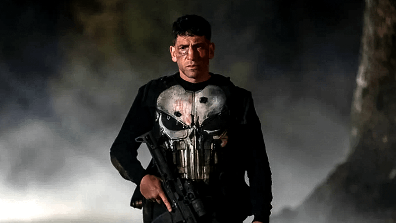 Jon Bernthal as The Punisher in Skull top with gun in Netflix show.