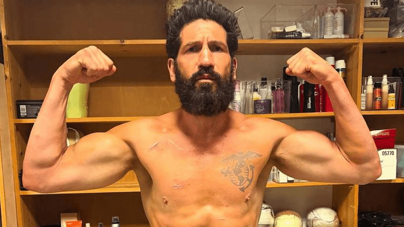 Jon Bernthal posing as Punisher flerxing his muscles on the set of Spider-Man: Brand New Day