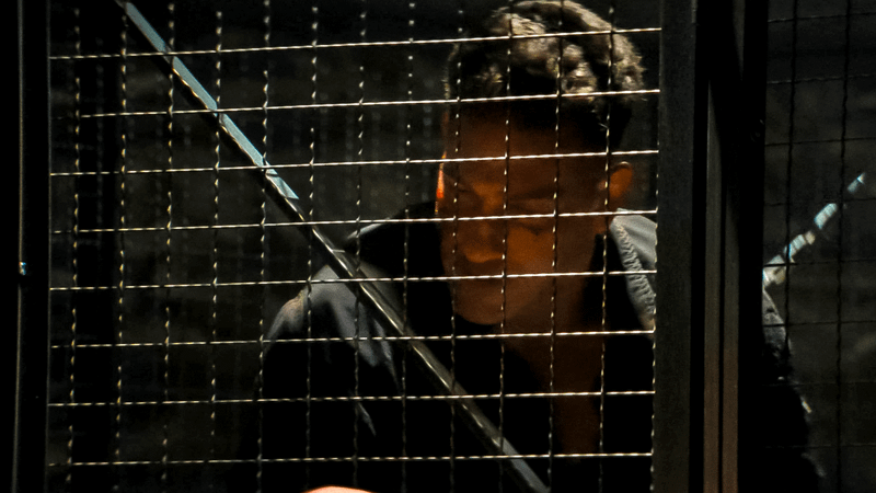 Jon Bernthal as Frank Castle looking out from behind a metal cage in Daredevil: Born Again.