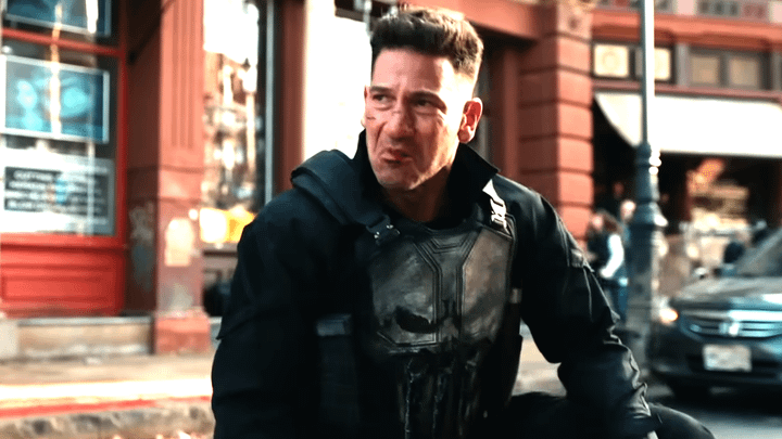 Jon Bernthal as Frank Castle sitting on the ground.