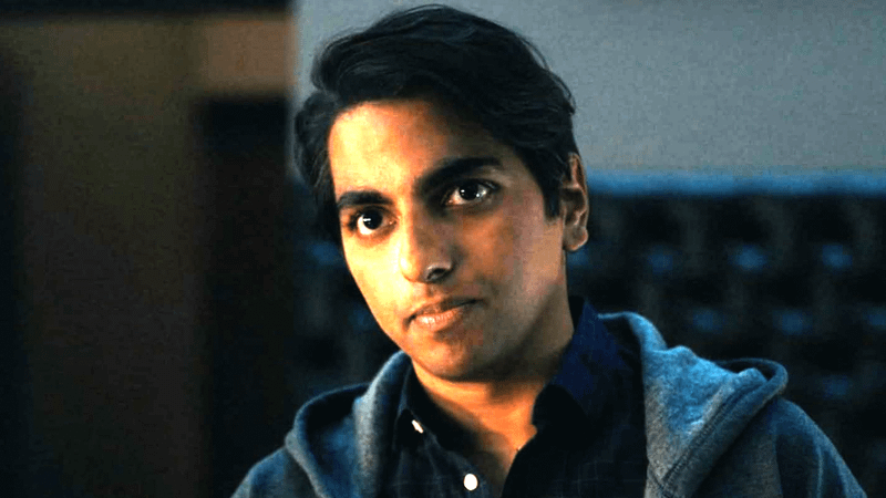 Rama Vallury looking off-camera and tilting his head.