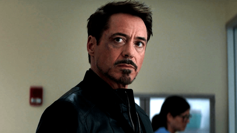 Robert Downey, Jr. as Tony Stark, looking stern in a black jacket in the Marvel Cinematic Universe.
