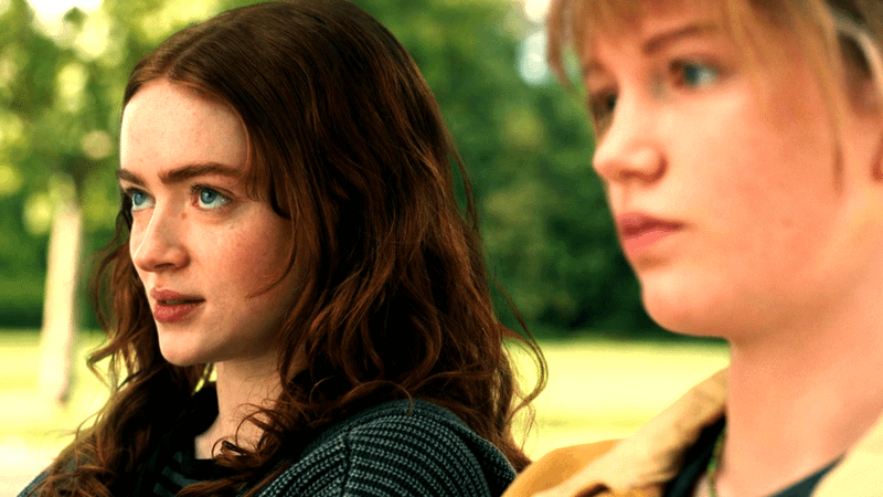 Sara and Jean Grey sitting on a bench.