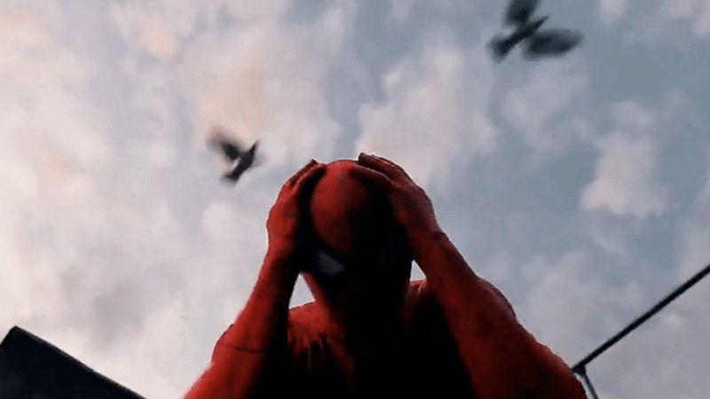 Spider-Man holding his head with birds flying over.