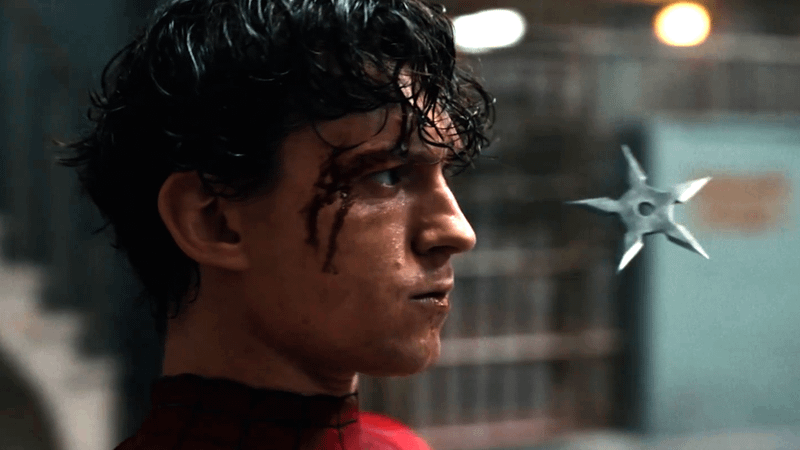 A shuriken flying past Spider-Man's head.