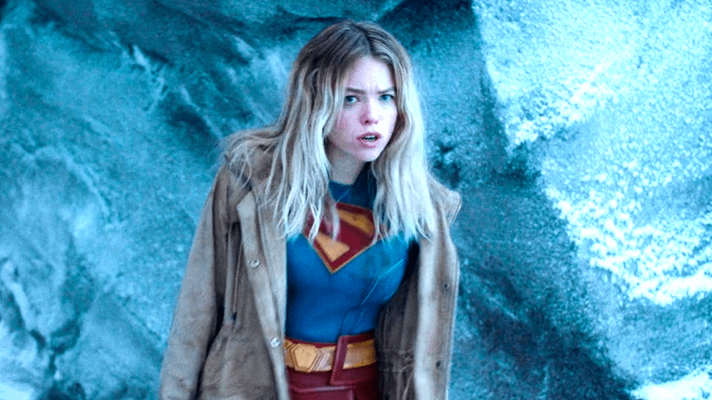 Milly Alcock as Supergirl standing in the Fortess of Solitude in a jacket and super suit in Superman