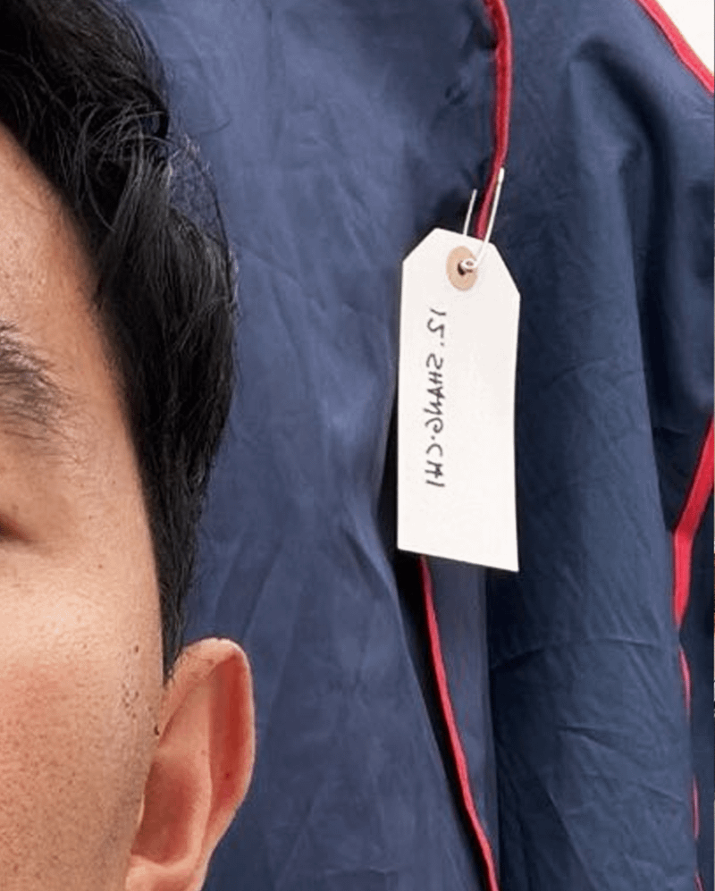Simu Liu next to Shang-Chi costume bag