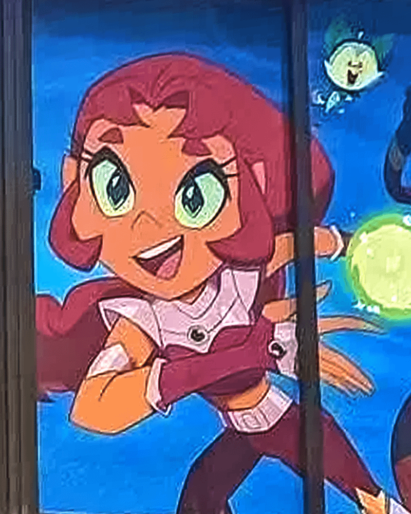 Starfire opens her bright green eyes and smiles broadly.