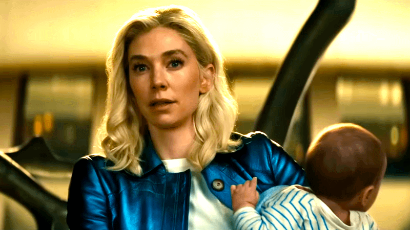 Vanessa Kirby as Sue Storm standing with Franklin Richards in her arms in Fantastic Four: First Steps