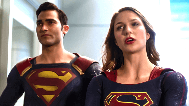 Melissa Benoist Supergirl standing in front of Tyler Hoechlin Superman.