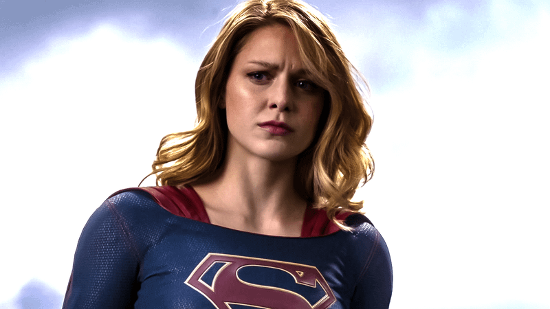 Melissa Benoist Supergirl in front of sky background.