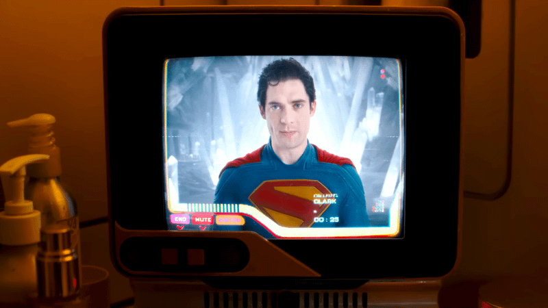 Clark Kent talking on a screen to Supergirl.