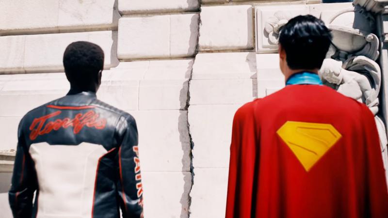 David Corenswet as Superman and Edi Gathegi as Mister Terrific looking at a crack in a building in Superman