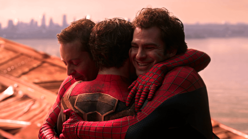 Tom Holland, Andrew Garfield and Tobey Maguire Spider-Men embrace in Spider-Man: No Way Home.