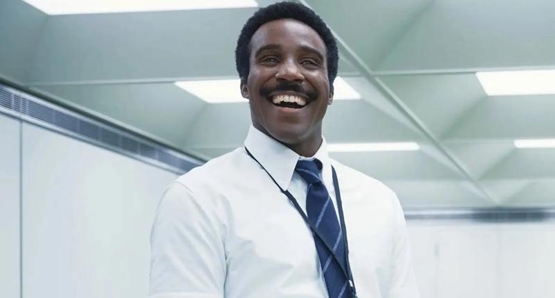 Tramell Tillman as Mr. Milchick smiling in Severance