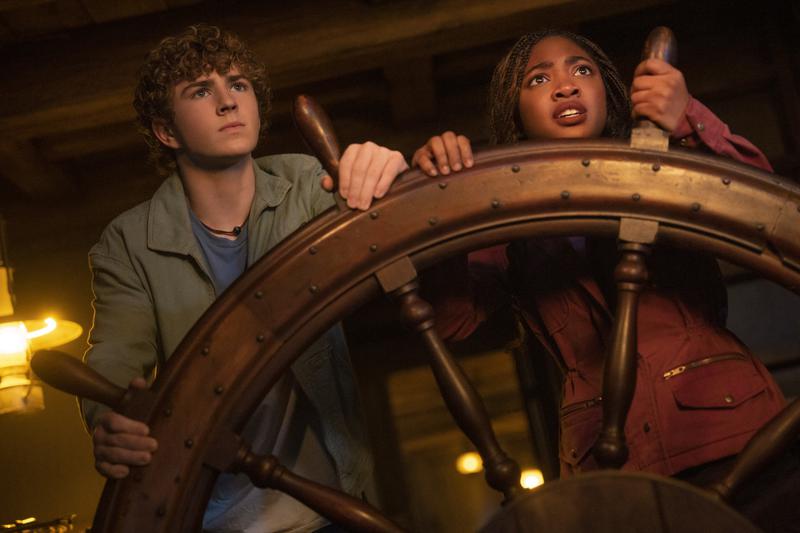 Walker Scobell as Percy Jackson and Leah Sava Jeffries as Annabeth Chase steering a ship in 