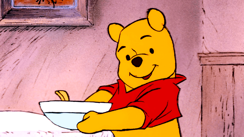 Winnie the Pooh holding a bowl