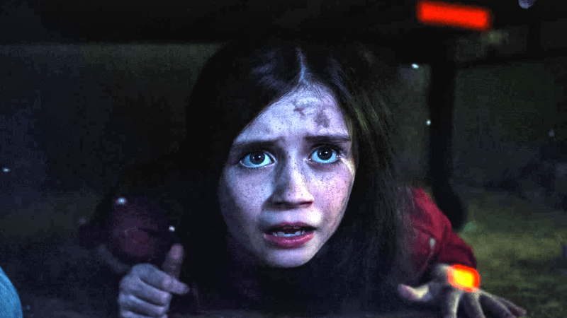 A young Wanda Maximoff hiding under a table in WandaVision.