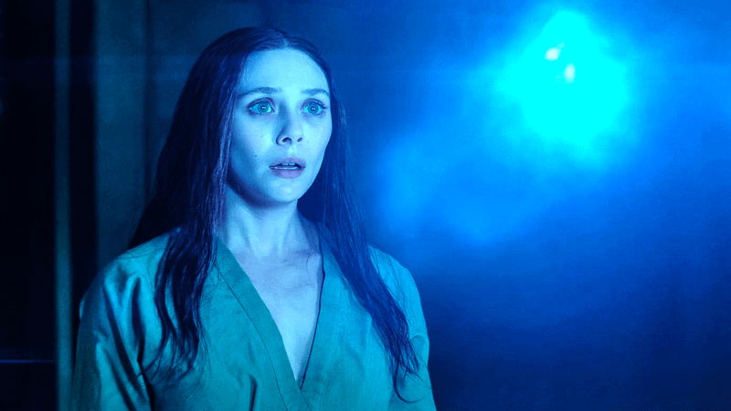 Elizabeth Olsen as Wand Maximoff looking at the Mind Stone in WandaVision.