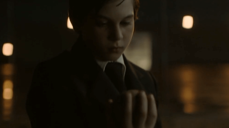 Young Hal Jordan picking up the baseball he threw.