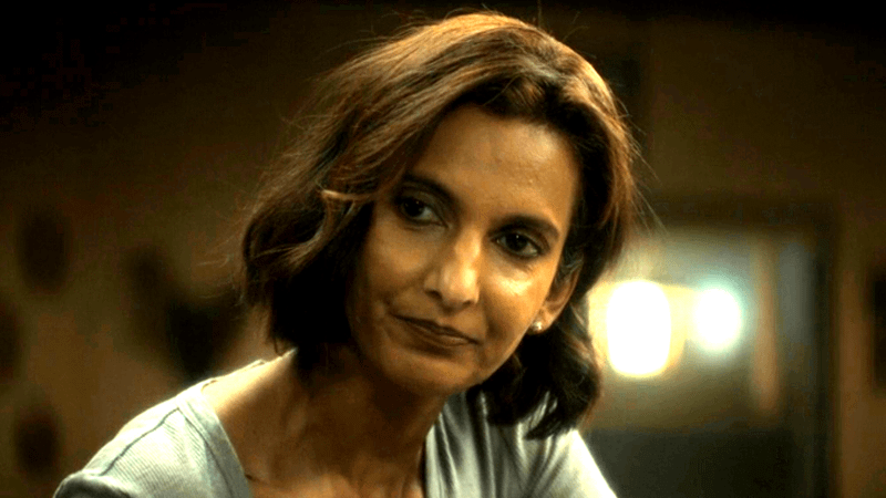Poorna Jagannathan's Zoe Macon talking to John Stewart.